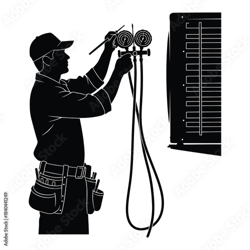 Silhouette of hvac technician checking refrigerant pressure with manifold gauges