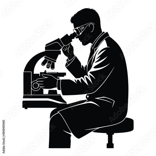 Scientist or researcher looking through a microscope in silhouette