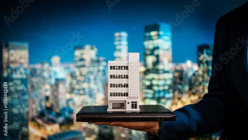 Obraz na plátně Business woman presenting detailed building model against vibrant city skyline, property development, investment stability, rental income potential, increasing value of immovable properties