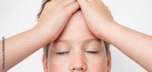 Close-up portrait teenage boy touching head with pain, suffering from headache or concussion, childhood trauma, stress, and health problems, Teen health and recovery, Pain and emotional struggle