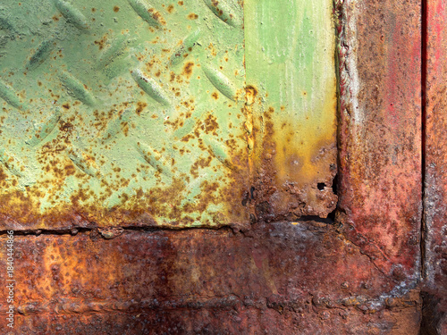Rust  corrosion on a steel door  . Advanced rust corrosion on a steel door surface  . close up of rust - induced corrosion and material degradation on steel  .