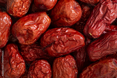 Pile of dried Chinese jujube fruit (red dates) for background. Close-up