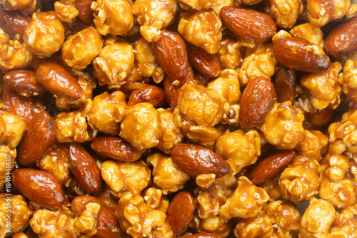 Top view of caramel popcorn with almonds for background