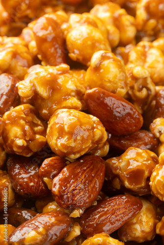 Pile of caramel popcorn with almonds rotating for background. Close-up