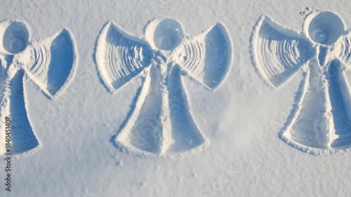 Snow-covered angel ornaments in a winter landscape
