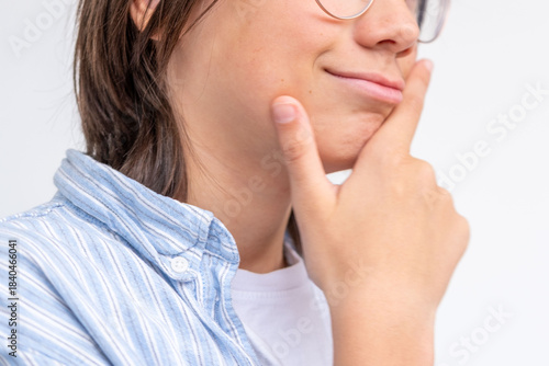 Close-up portrait smiling boy with glasses, happy laughing teenage, joyful emotion, youth happiness and spontaneity, authentic smile, positive mood, focusing on joyful expression and relaxed demeanor