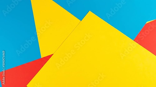 A vibrant abstract composition features intersecting sheets of primary colors, creating a dynamic, geometric aesthetic