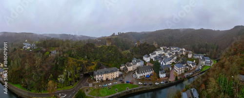 Esch-Sur-Sure, Wiltz, Grand Duche De Luxembourg, December 7, 2025, Wide Panoramic Of River Meander And Clustered Village Beneath Wooded Hills, Long View Captures Looping