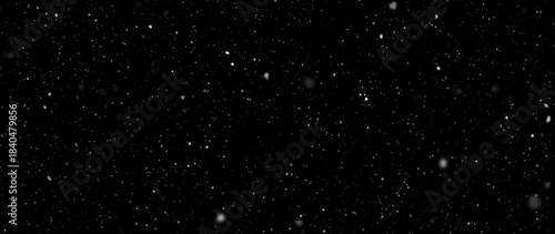 Fotografie Falling snowflakes out of focus on black background for overlay blending mode