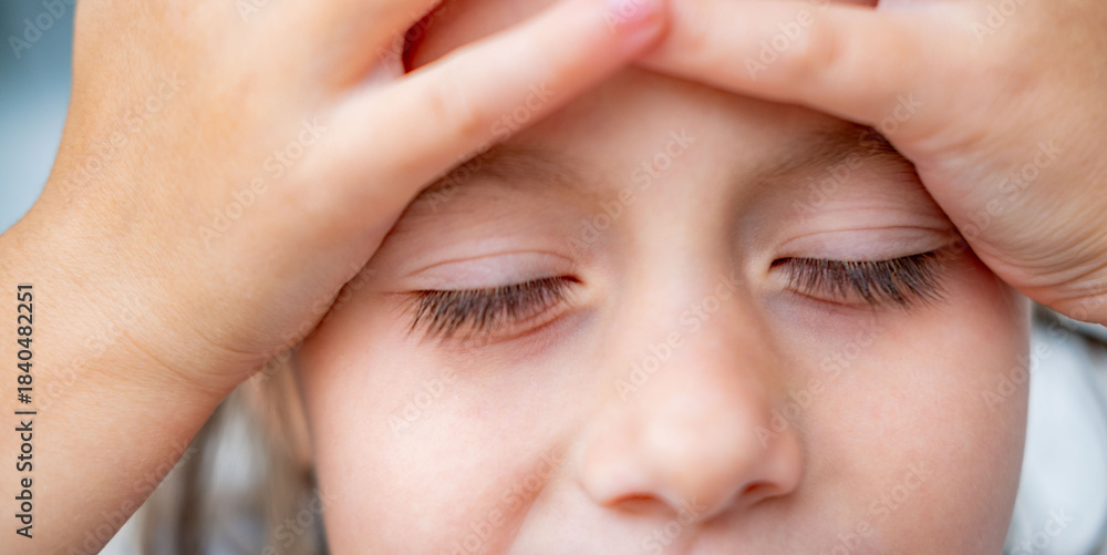 Fototapeta premium crying little girl, holding head, suffering from headache after fall, Overwhelmed elementary school child, looking sad and weak, conveying stress, fatigue, moments hurt, disappointment, overwhelming
