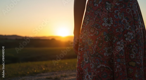 Woman in Floral Dress at Sunset, Warm Golden Hour Light