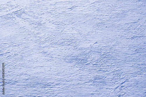 Textured light blue plaster surface with rough patterns and subtle natural brush strokes