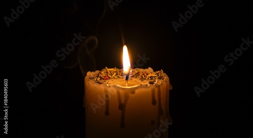 Single Dripping Yellow Candle Flame in Dark Background