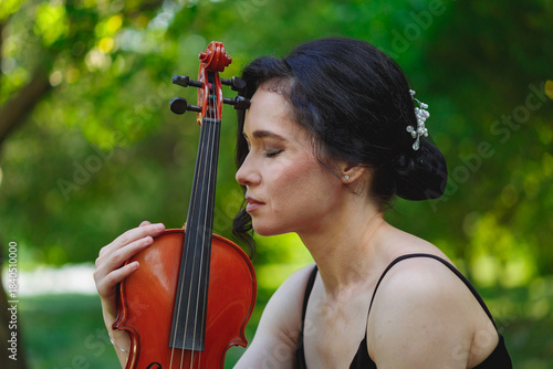 Violinist deeply connected with her instrument outdoors