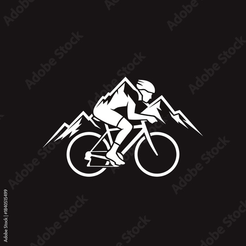 Mountain biker silhouette against snowy peaks