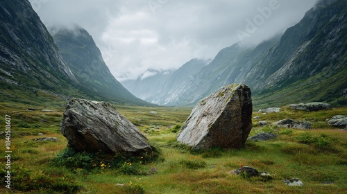 Mountain valley with two large rocks under a cloudy sky