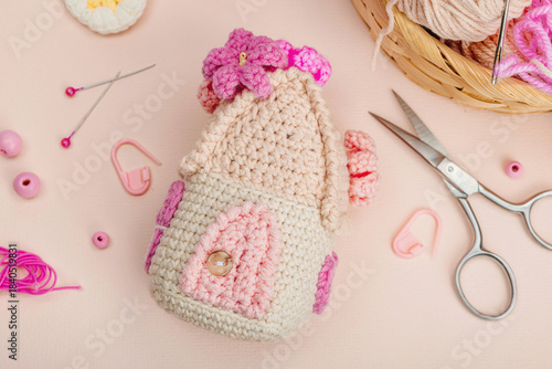 Handmade spring decor concept. Creative crocheting, house figurine, traditional flowers and hearts