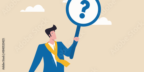 A man in a suit presents a question mark on a circular sign