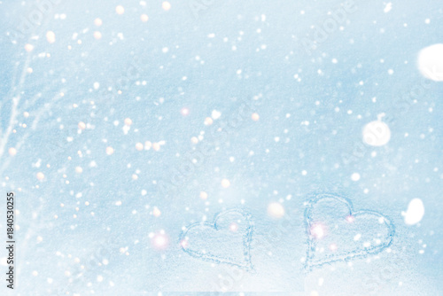 Valentine's Day. Abstract winter soft background with two hearts in the snow.