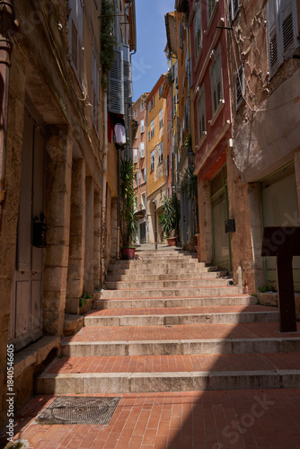 Grasse, France - June 12, 2025 - charming alleyway with buildings in a European town on a sunny day