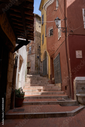 Grasse, France - June 12, 2025 - charming alleyway with buildings in a European town on a sunny day