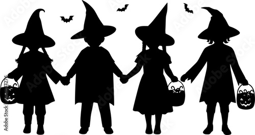 Silhouettes of children in halloween costumes holding hands and candy buckets 