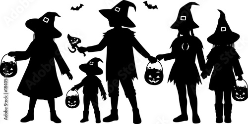 Silhouettes of children in halloween costumes holding hands and candy buckets 