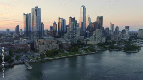 Aerial view of a city skyline at dusk, with skyscrapers along the water