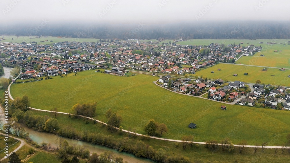Fototapeta premium Rural homes and distant alpine peaks