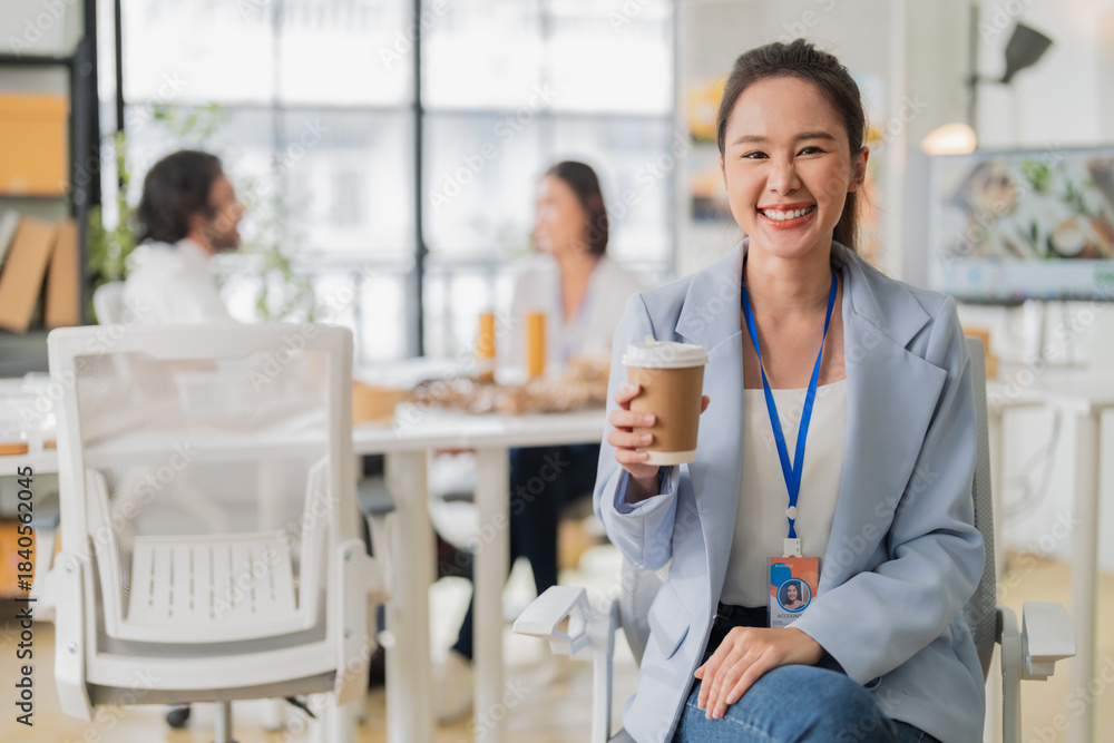 Fototapeta premium portrait captures a smart, confident Asian woman leading an office meeting, brainstorming ESG and upcycled material packaging ideas as a corporate leader