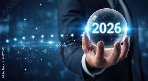 Businessman holding crystal ball with 2026, representing future predictions and technology trends. image conveys sense of innovation and foresight