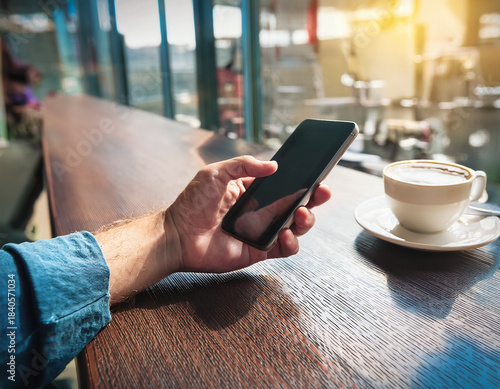 Hands Using Smartphone at Outdoor Cafe With Scenic Urban Background View