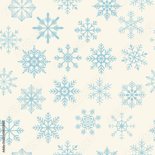 Blue snowflakes on a light background, the colors of the year. Seamless Christmas pattern. Winter holiday concept. Repeatable design for decor, wallpaper, packaging, and websites.