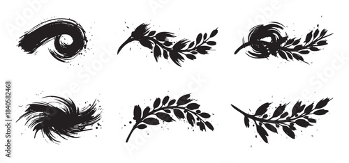 Ink brush strokes and leafy branches showcase a versatile collection of artistic grunge design elements featuring textured splatters and organic shapes.