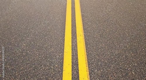 Wallpaper Mural Asphalt Road with Double Yellow Lines Undergoing Seasonal Transformation Time-lapse. Dynamic Weather Changes from Winter Snow to Spring Rain, Summer Dry, and Autumn Leaves. Torontodigital.ca