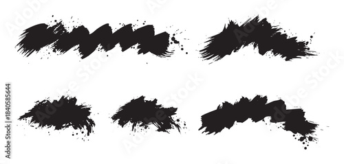 Black ink brush strokes set with various artistic textures and splatters creating a dynamic and expressive graphic design element for creative projects.