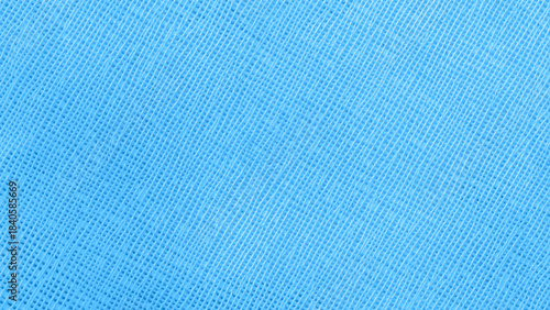 Macro shot of bright blue textile texture with linear grid pattern. Natural background with subtle fabric texture, trendy color design