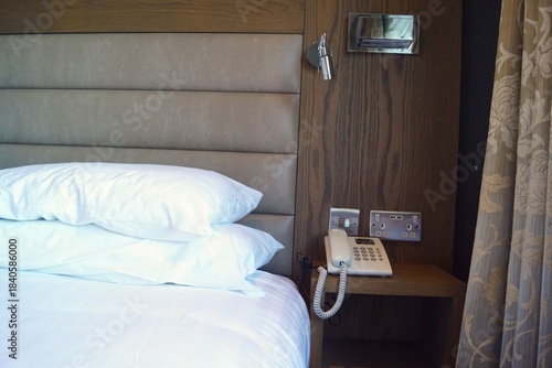 bed and landline telephone in the hotel room