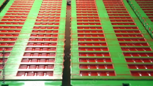 Chocolate bar production line with icing and liquid filling moving on conveyor belt in confectionery factory.
