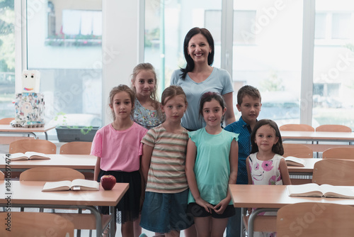 Portrait of children in a preschool institution with their teacher in a torn classroom. Selective focus