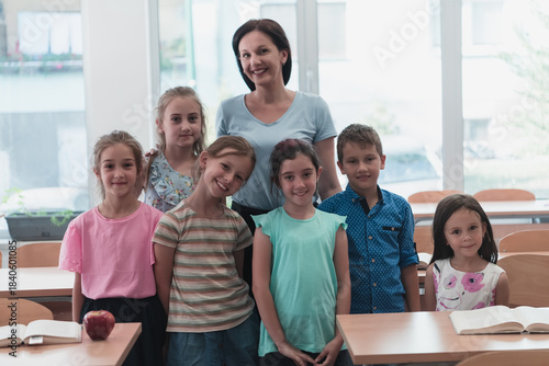 Portrait of children in a preschool institution with their teacher in a torn classroom. Selective focus