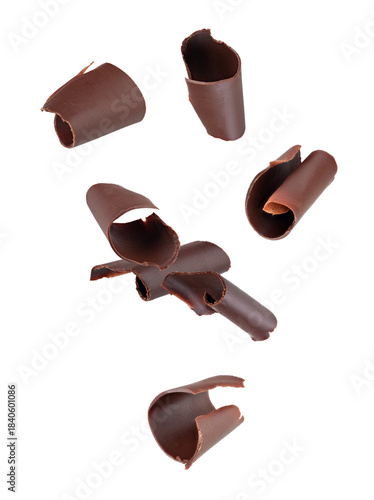 Chocolate curls fall into space. Isolated on white.