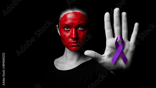 Woman with red face paint and her hand in a STOP sign, holding a purple ribbon in her hand as an awareness campaign against violence. Depicting violence against women. Femicide.