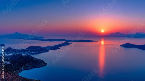 Stunning panoramic view of calm water, islands, and a brilliant, radiant sunset in the sky