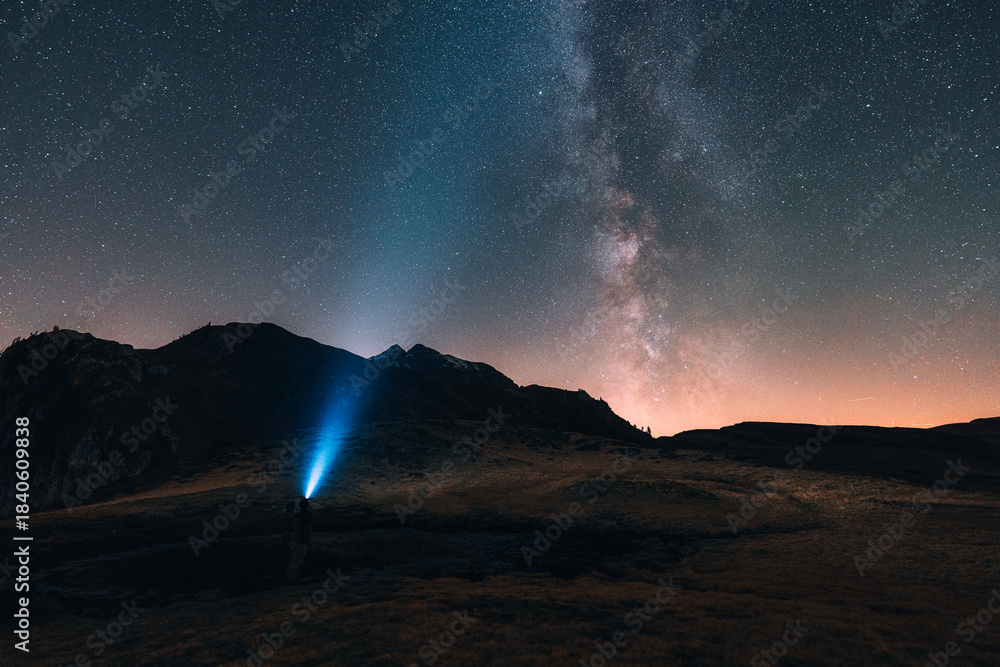 Naklejka premium Milky way shining over mountain and pond in Dolomites, Italy