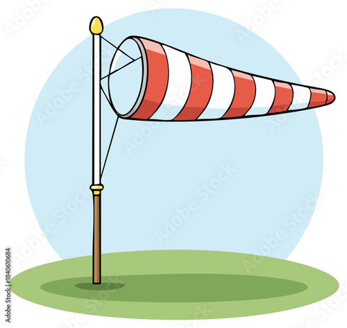 Red and white striped windsock indicating wind direction on a pole in a field