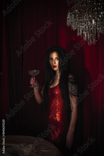 Gorgeous brunette European woman in sparkle red dress at party, fashionable concept