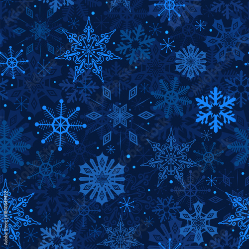 Snowflakes on blue background winter seamless pattern. Christmas New year holiday backdrop. Snow stars in night sky. Deep blue winter repeat design for textile fabric, wrapping paper, packaging print.