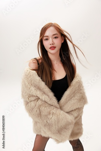 Confident Glamorous Asian Woman Posing in Luxury Fur Coat Ready for a Party.