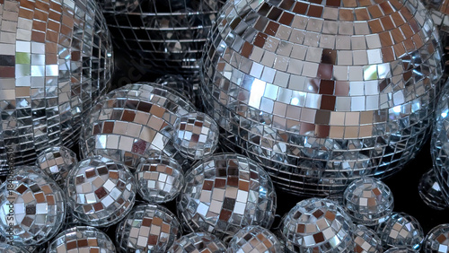 Shimmering disco balls arranged in various sizes, reflecting light and creating a dazzling visual effect